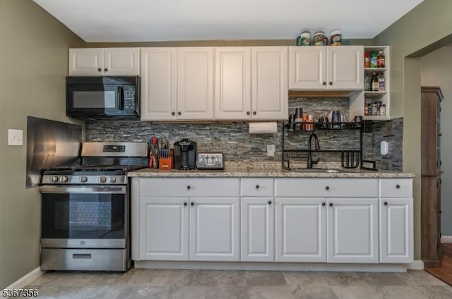 302 Chambers St, Phillipsburg Town, NJ 08865 - kitchen featuring black microwave, gas stove, white cabinets, tasteful backsplash, and light stone counters