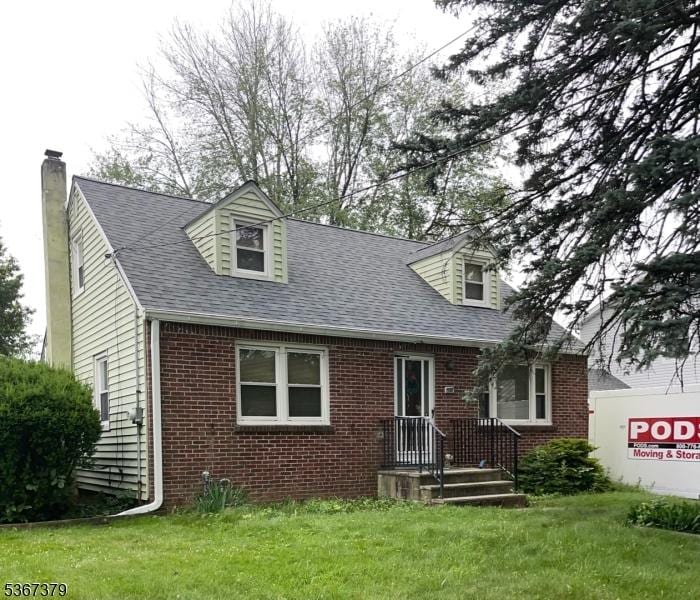 1598 Front St, Scotch Plains Twp, NJ 07076 - cape cod home with brick siding, a front lawn, a chimney, and roof with shingles