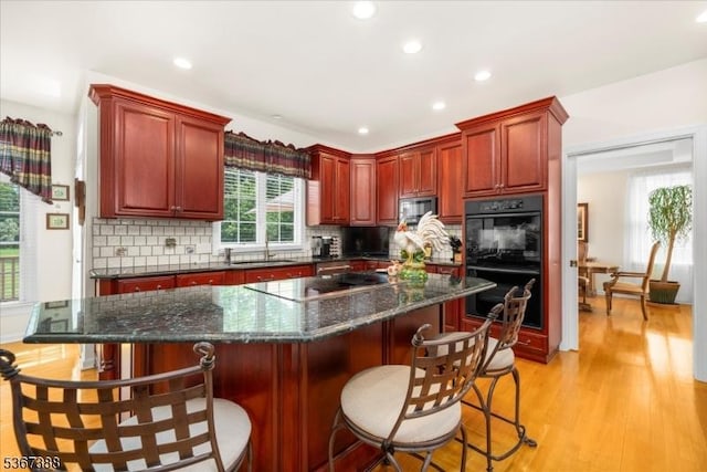 3 Stanbury Ln, Kingwood Twp, NJ 08825 - kitchen featuring black appliances, reddish brown cabinets, recessed lighting, and tasteful backsplash