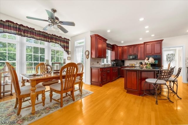 3 Stanbury Ln, Kingwood Twp, NJ 08825 - kitchen featuring oven, reddish brown cabinets, dark countertops, light wood-style floors, and recessed lighting
