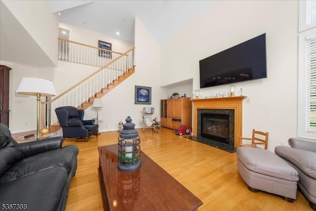 3 Stanbury Ln, Kingwood Twp, NJ 08825 - living room featuring stairway, a fireplace, wood finished floors, and high vaulted ceiling