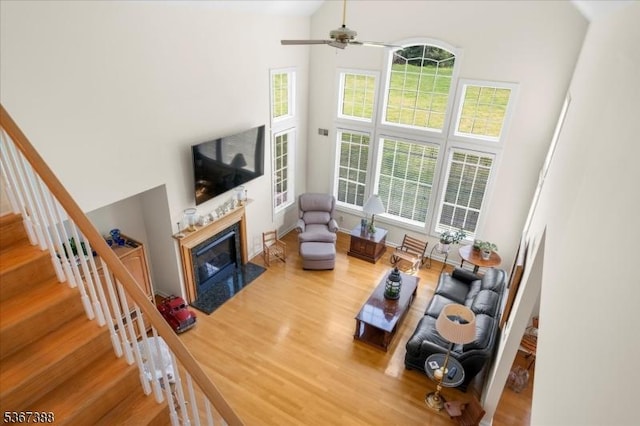 3 Stanbury Ln, Kingwood Twp, NJ 08825 - living room with wood finished floors, a fireplace with flush hearth, a ceiling fan, plenty of natural light, and a towering ceiling