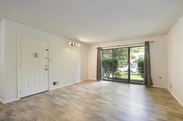 136 Woodward Ln, Bernards Twp, NJ 07920 - empty room featuring a textured ceiling and light wood-style flooring