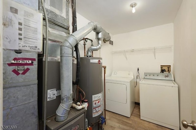 136 Woodward Ln, Bernards Twp, NJ 07920 - washroom featuring gas water heater, independent washer and dryer, and light wood-style flooring