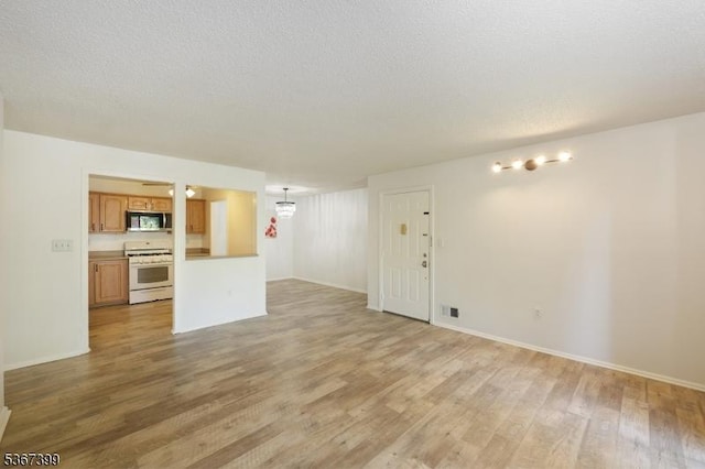 136 Woodward Ln, Bernards Twp, NJ 07920 - unfurnished living room with light wood-type flooring and baseboards