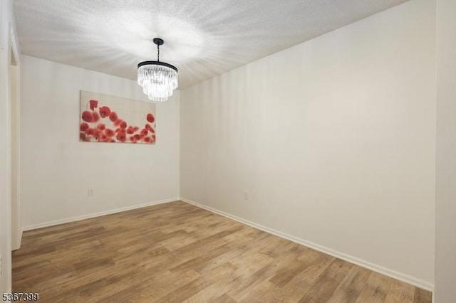 136 Woodward Ln, Bernards Twp, NJ 07920 - spare room with a chandelier and light wood-style floors