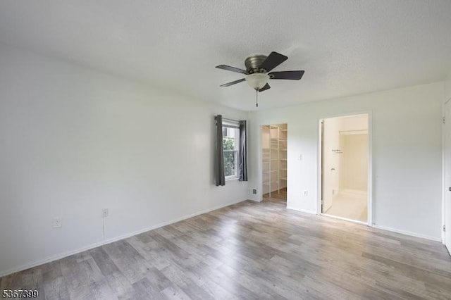 136 Woodward Ln, Bernards Twp, NJ 07920 - unfurnished bedroom featuring wood finished floors, a walk in closet, a ceiling fan, connected bathroom, and a closet