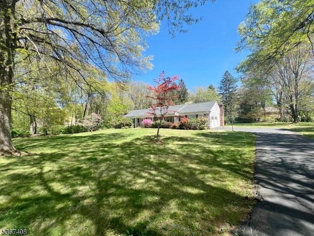 11 Dean Rd, Mendham Boro, NJ 07945 - ranch-style house with driveway, a garage, and a front lawn