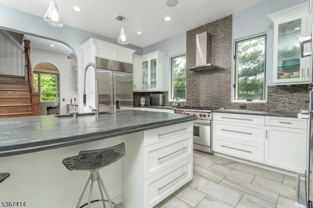 39 Crescent Dr, Morris Twp, NJ 07960 - kitchen featuring high quality appliances, wall chimney range hood, tasteful backsplash, recessed lighting, and white cabinetry