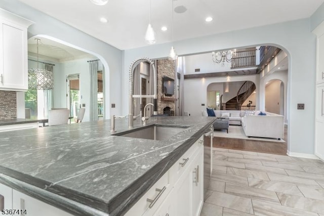 39 Crescent Dr, Morris Twp, NJ 07960 - kitchen featuring arched walkways, recessed lighting, a chandelier, open floor plan, and dark stone countertops