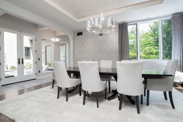 39 Crescent Dr, Morris Twp, NJ 07960 - dining area featuring a tray ceiling, a chandelier, arched walkways, french doors, and wood finished floors