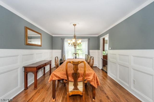 14 Windjammer Dr, Jefferson Twp, NJ 07849 - dining room featuring a chandelier, ornamental molding, wainscoting, a decorative wall, and light wood-style flooring