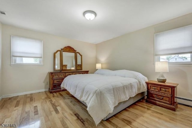830 Pennsylvania Ave, Lyndhurst Twp, NJ 07071 - bedroom with light wood-style flooring and a baseboard heating unit