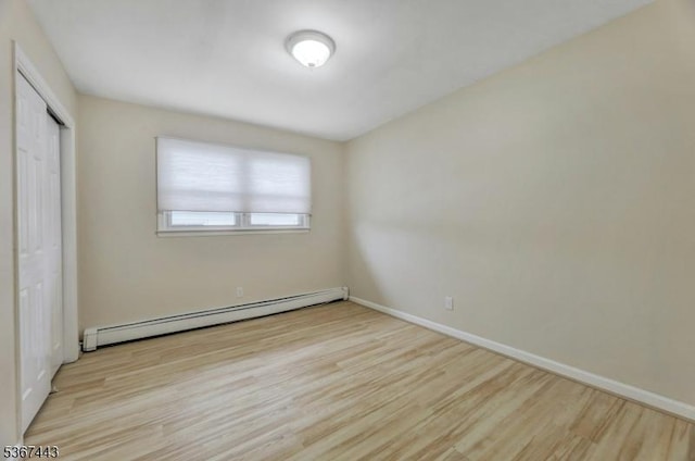 830 Pennsylvania Ave, Lyndhurst Twp, NJ 07071 - unfurnished bedroom with a baseboard heating unit, wood finished floors, and a closet