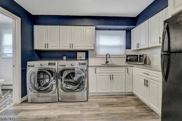 830 Pennsylvania Ave, Lyndhurst Twp, NJ 07071 - laundry area with healthy amount of natural light, washer and dryer, light wood-style floors, and baseboard heating