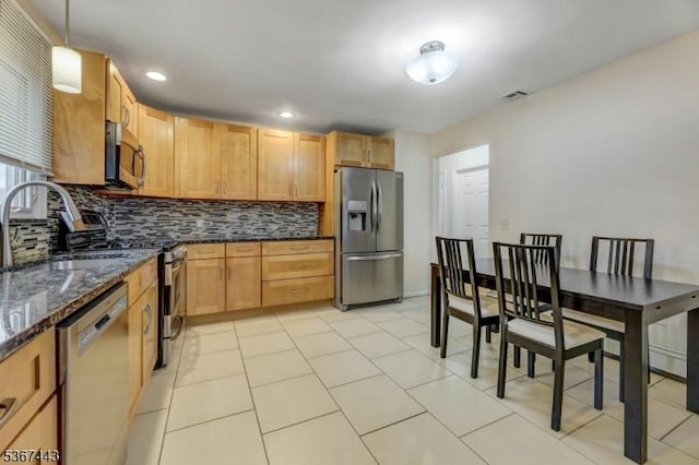 830 Pennsylvania Ave, Lyndhurst Twp, NJ 07071 - kitchen with appliances with stainless steel finishes, backsplash, dark stone countertops, recessed lighting, and pendant lighting