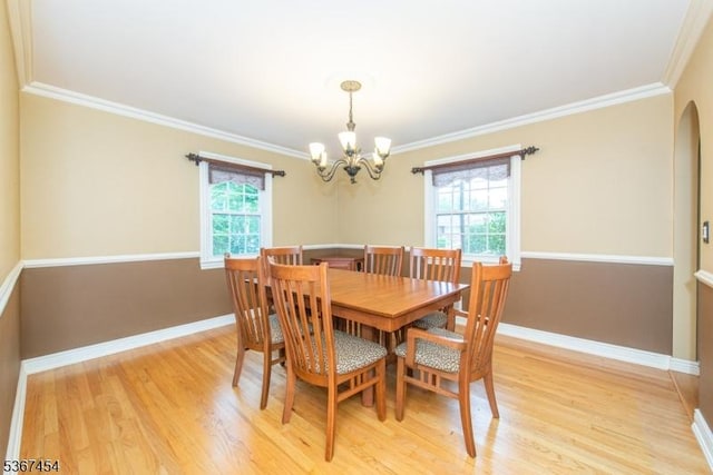 88 Overlook Ave, East Hanover Twp, NJ 07936 - dining room featuring a chandelier, light wood-style floors, ornamental molding, and arched walkways