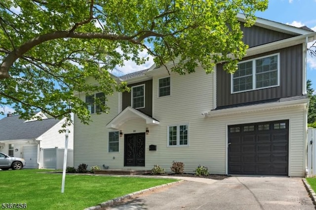 331 W Ln, Clark Twp, NJ 07066 - view of front of house featuring board and batten siding, a garage, and driveway