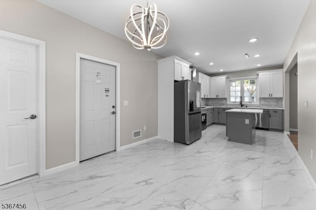 331 W Ln, Clark Twp, NJ 07066 - kitchen with appliances with stainless steel finishes, a chandelier, recessed lighting, light countertops, and a kitchen island