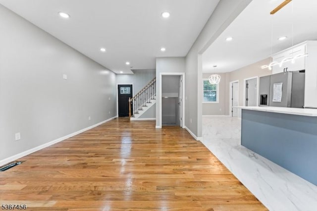 331 W Ln, Clark Twp, NJ 07066 - unfurnished living room with stairway, recessed lighting, light wood-style flooring, and a chandelier