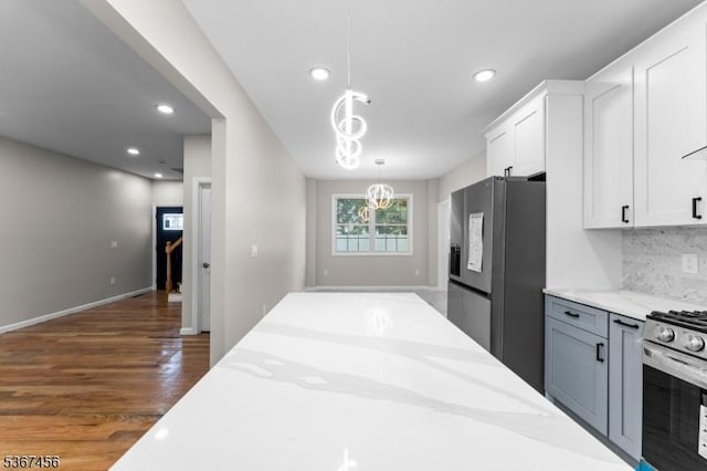 331 W Ln, Clark Twp, NJ 07066 - kitchen with stainless steel appliances, white cabinetry, wood finished floors, decorative light fixtures, and light stone countertops