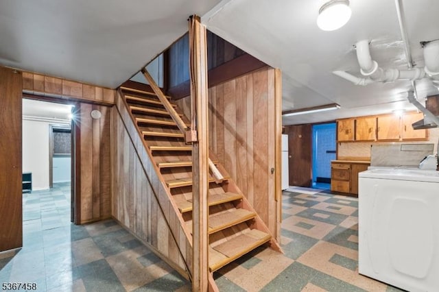 917 Tompkins Ave, South Plainfield Boro, NJ 07080 - finished below grade area with washer / dryer, tile patterned floors, stairs, wood walls, and freestanding refrigerator