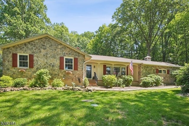 471 W Hill Rd, Lebanon Twp, NJ 08826 - view of front facade featuring stone siding, a front lawn, and covered porch
