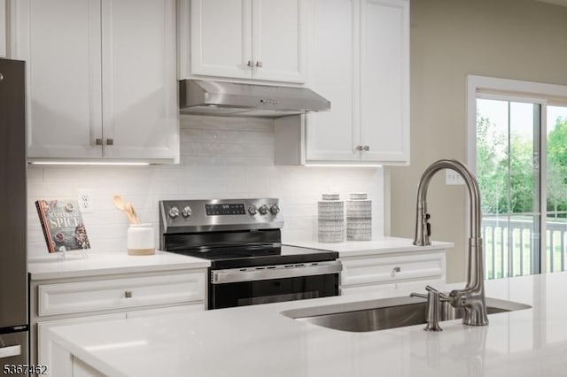 7 Glacier Way, Union Twp, NJ 08867 - kitchen featuring appliances with stainless steel finishes, under cabinet range hood, light countertops, white cabinetry, and decorative backsplash