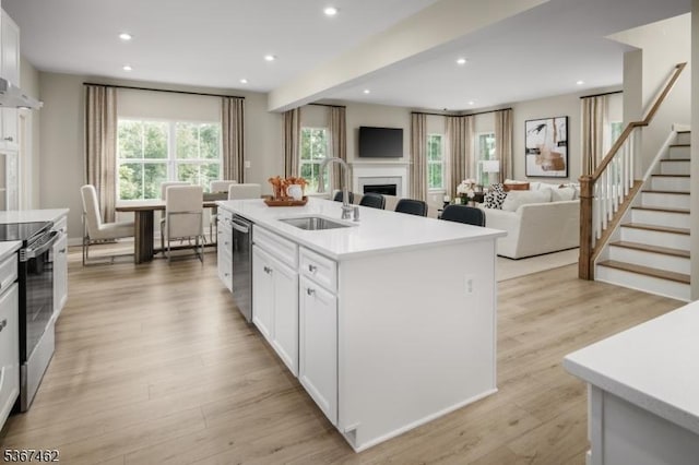 7 Glacier Way, Union Twp, NJ 08867 - kitchen featuring a fireplace, appliances with stainless steel finishes, light countertops, white cabinets, and recessed lighting