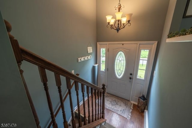 37 Evergreen Rd, Vernon Twp, NJ 07461 - entrance foyer with a chandelier, stairway, wood finished floors, and a high ceiling