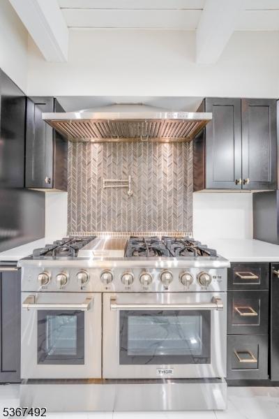 17 Glenwood Rd, Colts Neck Twp, NJ 07722 - kitchen with range with two ovens, decorative backsplash, light countertops, and wall chimney range hood