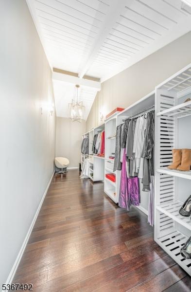 17 Glenwood Rd, Colts Neck Twp, NJ 07722 - spacious closet with dark wood finished floors, beamed ceiling, and a chandelier