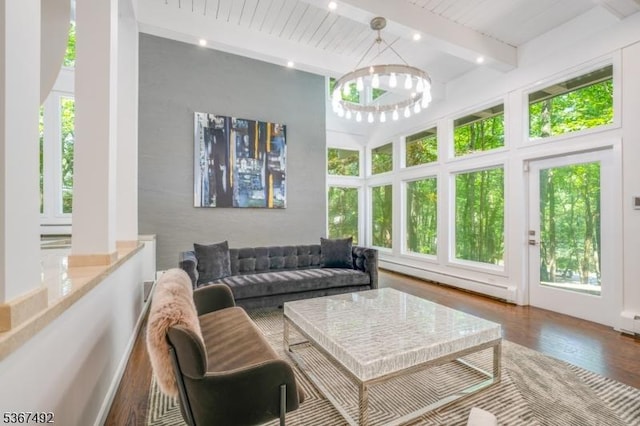 17 Glenwood Rd, Colts Neck Twp, NJ 07722 - living room with beam ceiling, baseboard heating, wood finished floors, and a chandelier