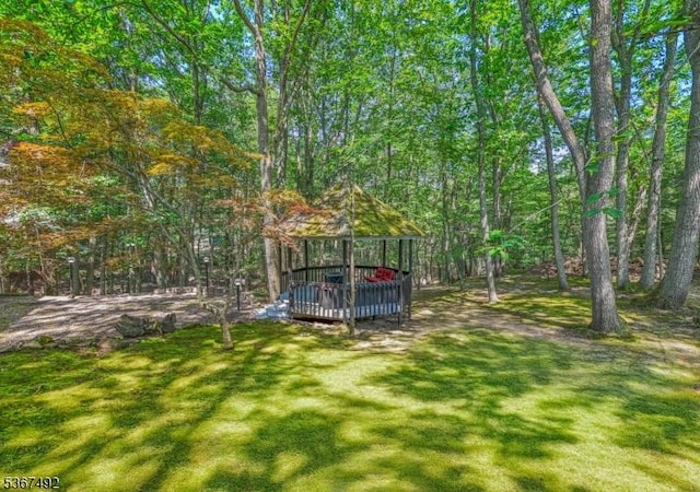 17 Glenwood Rd, Colts Neck Twp, NJ 07722 - view of grassy yard featuring a wooden deck and a view of trees