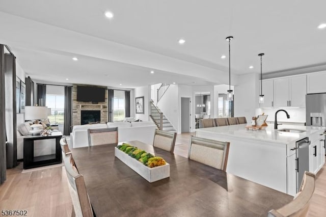 14 Glacier Way, Union Twp, NJ 08867 - dining area featuring stairway, a large fireplace, recessed lighting, and light wood finished floors