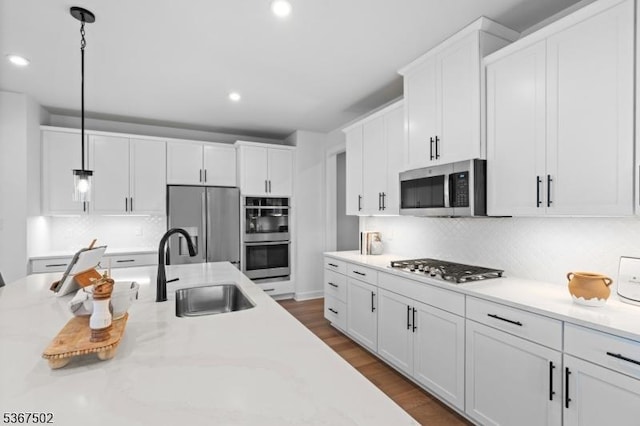 14 Glacier Way, Union Twp, NJ 08867 - kitchen with appliances with stainless steel finishes, white cabinetry, decorative backsplash, pendant lighting, and recessed lighting