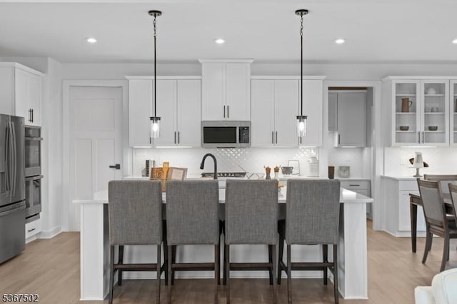 14 Glacier Way, Union Twp, NJ 08867 - kitchen featuring stainless steel appliances, tasteful backsplash, a center island with sink, light countertops, and recessed lighting