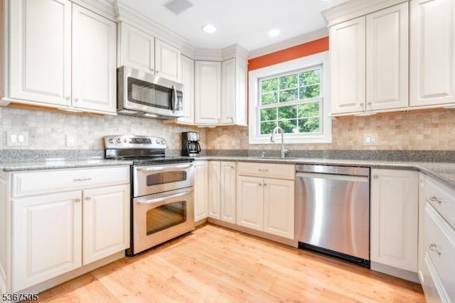 20 Scenic Dr, Fredon Twp, NJ 07860 - kitchen featuring appliances with stainless steel finishes, light wood-style floors, tasteful backsplash, light stone countertops, and recessed lighting