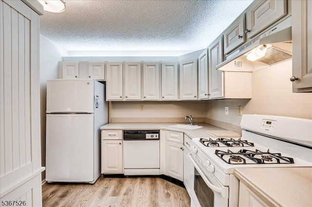 113 Lindsey Ct, Franklin Twp, NJ 08823 - kitchen with white appliances, under cabinet range hood, light countertops, light wood finished floors, and a textured ceiling