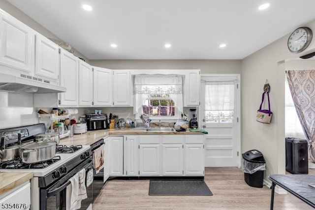 442 Stalevicz Ln, Rahway City, NJ 07065 - kitchen with range with gas cooktop, under cabinet range hood, light countertops, white cabinets, and light wood finished floors