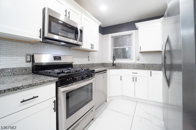 216 S 5th Ave, Manville Boro, NJ 08835 - kitchen with stainless steel appliances, white cabinets, backsplash, light stone countertops, and light marble finish flooring