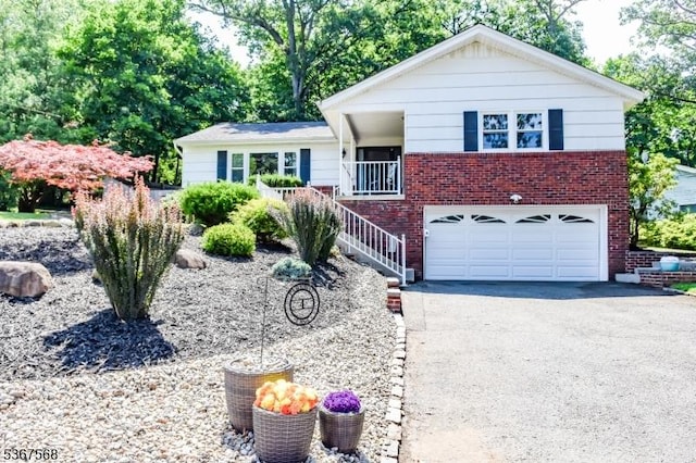 4 Parkway E, Caldwell Boro Twp, NJ 07006 - view of front of home with brick siding, driveway, an attached garage, and stairs