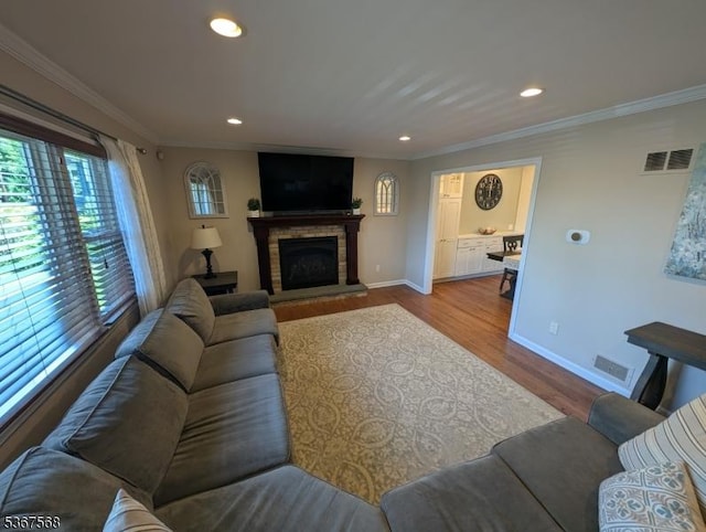 4 Parkway E, Caldwell Boro Twp, NJ 07006 - living area with wood finished floors, a stone fireplace, ornamental molding, and recessed lighting