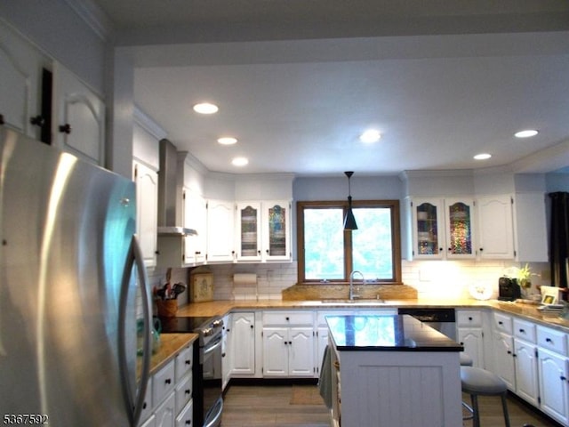 39 Stillwater Rd, Hardwick Twp, NJ 07825 - kitchen featuring appliances with stainless steel finishes, wall chimney range hood, ornamental molding, dark wood-type flooring, and white cabinetry