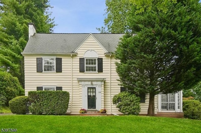 329 W End Rd, South Orange Village Twp, NJ 07079 - view of front facade with a front lawn, a chimney, and a shingled roof