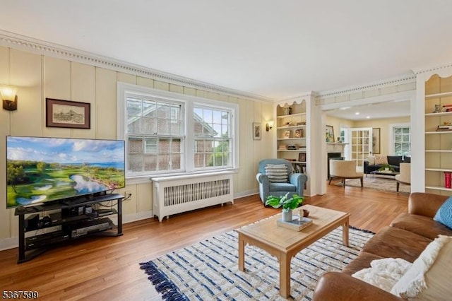 329 W End Rd, South Orange Village Twp, NJ 07079 - living area with radiator heating unit, plenty of natural light, light wood-type flooring, a fireplace, and crown molding