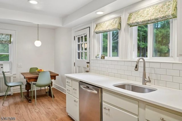 329 W End Rd, South Orange Village Twp, NJ 07079 - kitchen featuring stainless steel dishwasher, light countertops, decorative backsplash, decorative light fixtures, and light wood-type flooring
