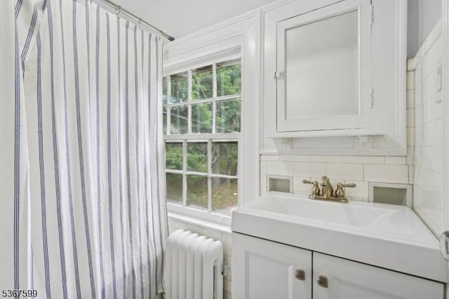 329 W End Rd, South Orange Village Twp, NJ 07079 - bathroom with radiator, vanity, and decorative backsplash