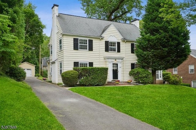 329 W End Rd, South Orange Village Twp, NJ 07079 - view of front of home featuring a chimney, a garage, a front yard, and an outdoor structure