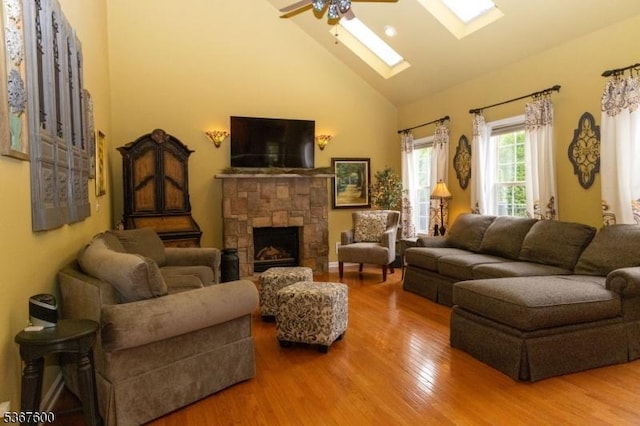 10 Links Ct, Sparta Twp, NJ 07871 - living area featuring high vaulted ceiling, a skylight, a ceiling fan, wood finished floors, and a stone fireplace